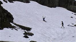 Michael slides down yet another snow slope after Olly's test run, 10.9 miles into the ride and 916m above sea level